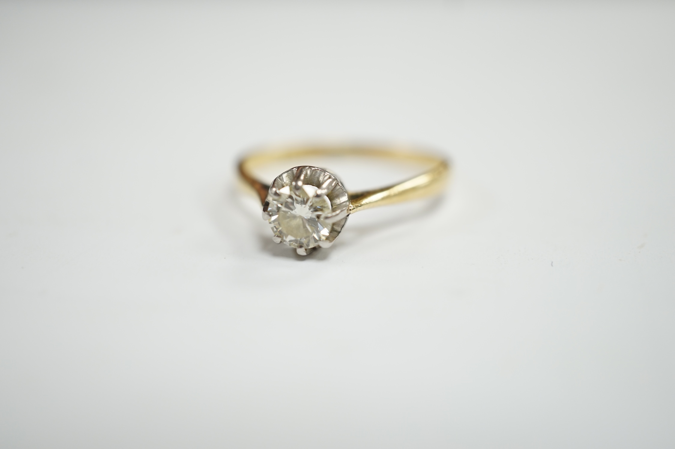 An early 20th century 18ct, plat and claw set solitaire diamond ring, size S, gross weight 2.8 grams.